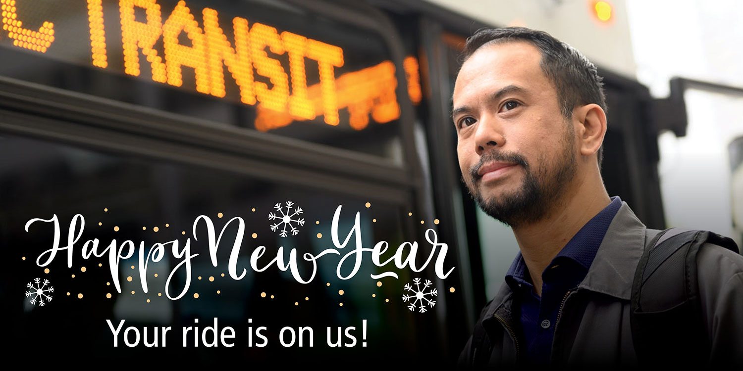 Photo of man in front of AC Transit bus stating: Happy New Year, You ride is on us. 