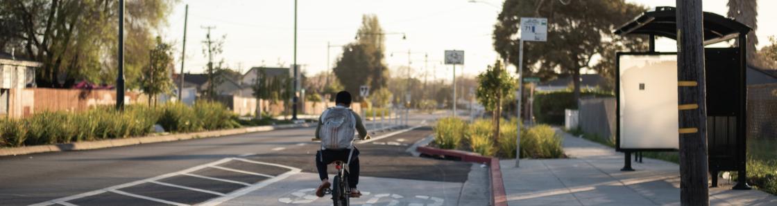 Bicyclist near AC Transit bus stop