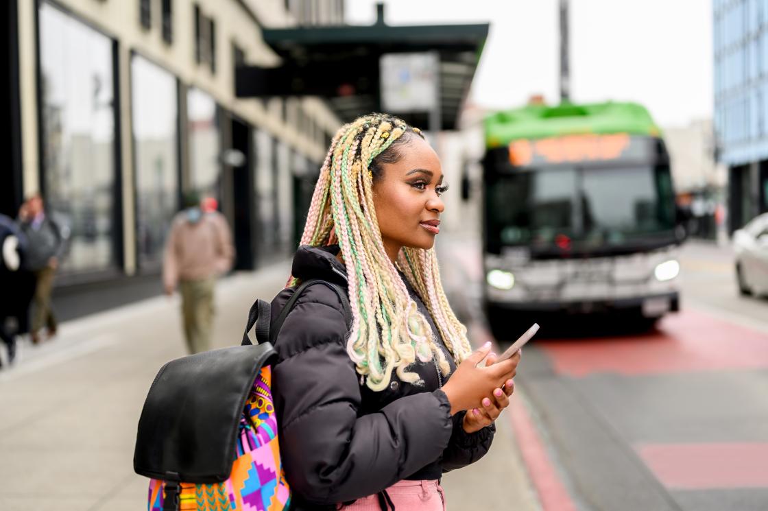 Woman on phone at bus stop