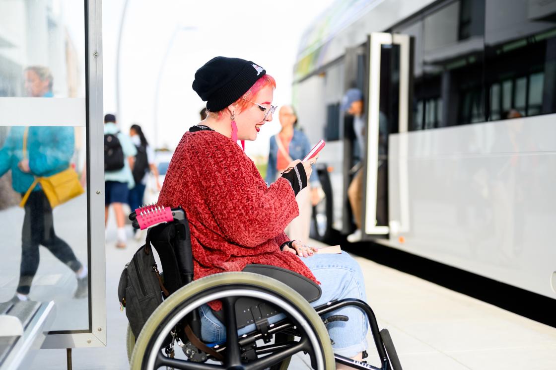 Woman on phone at bus stop